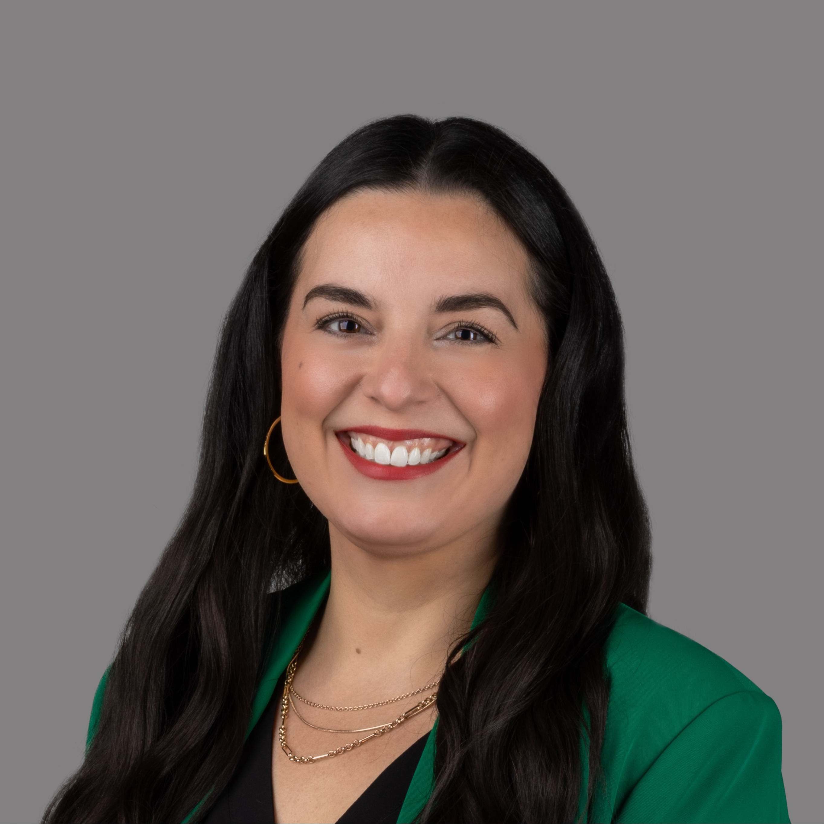 professional headshot of woman in green suit