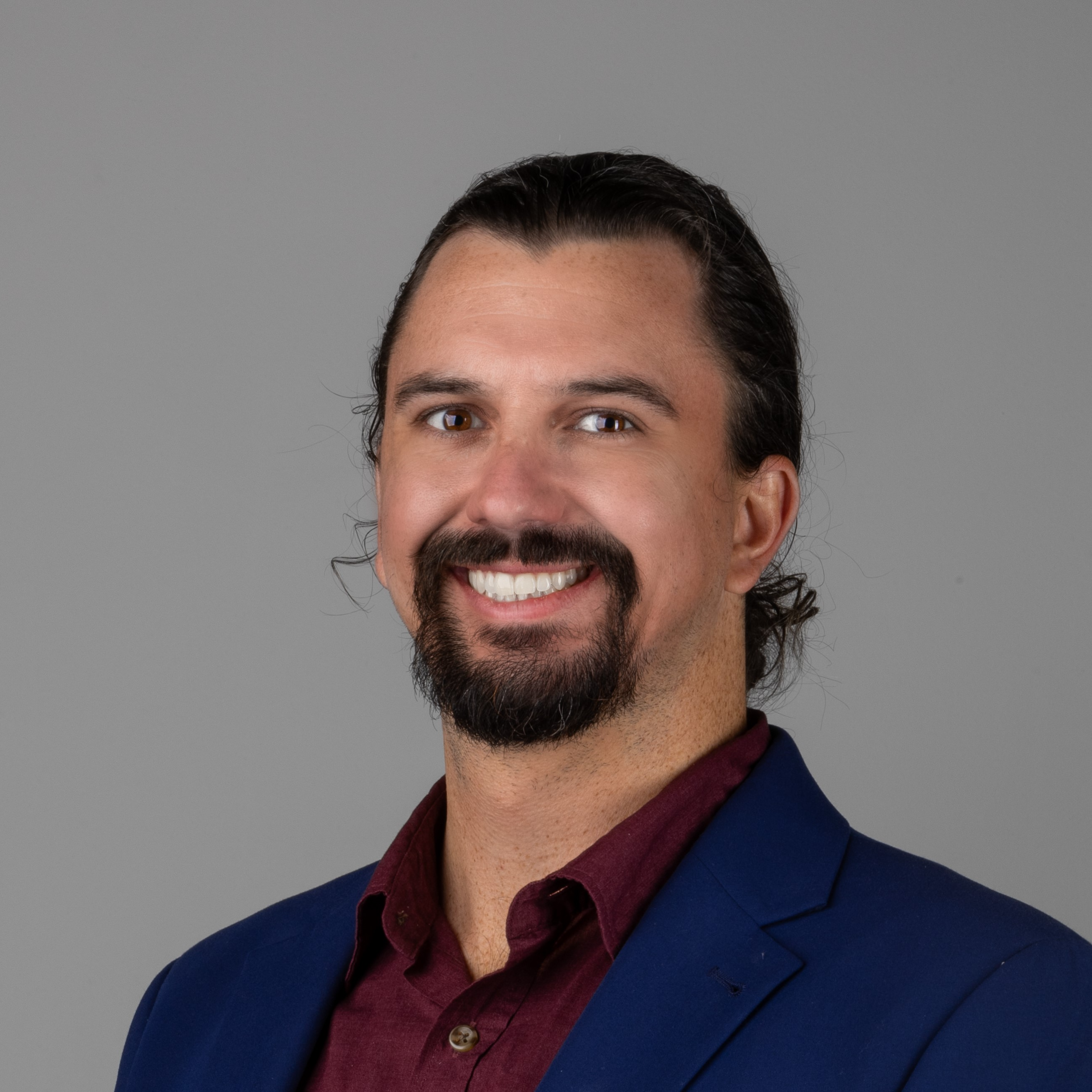 professional headshot of man in blue suit