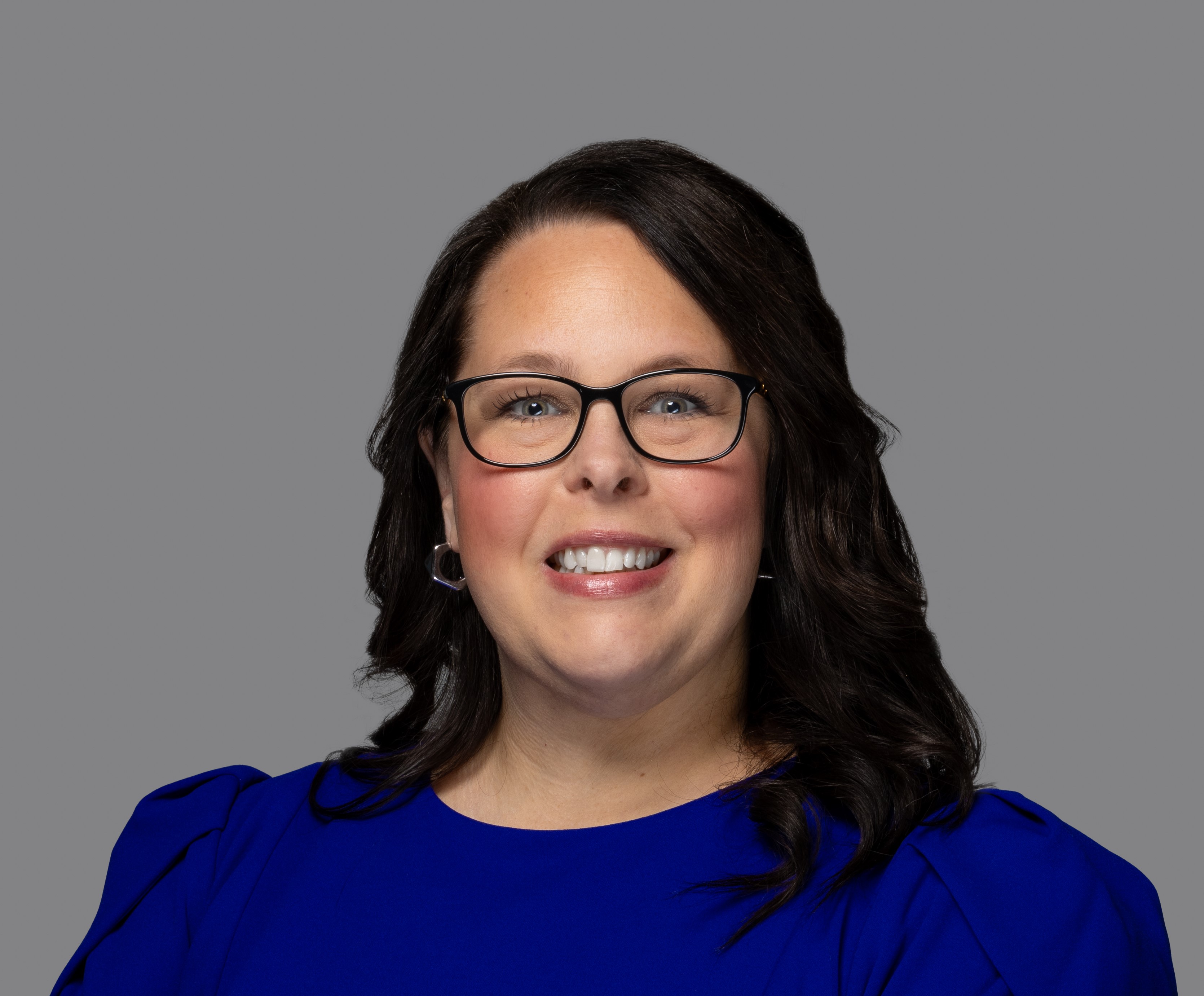 professional headshot of woman in blue dress