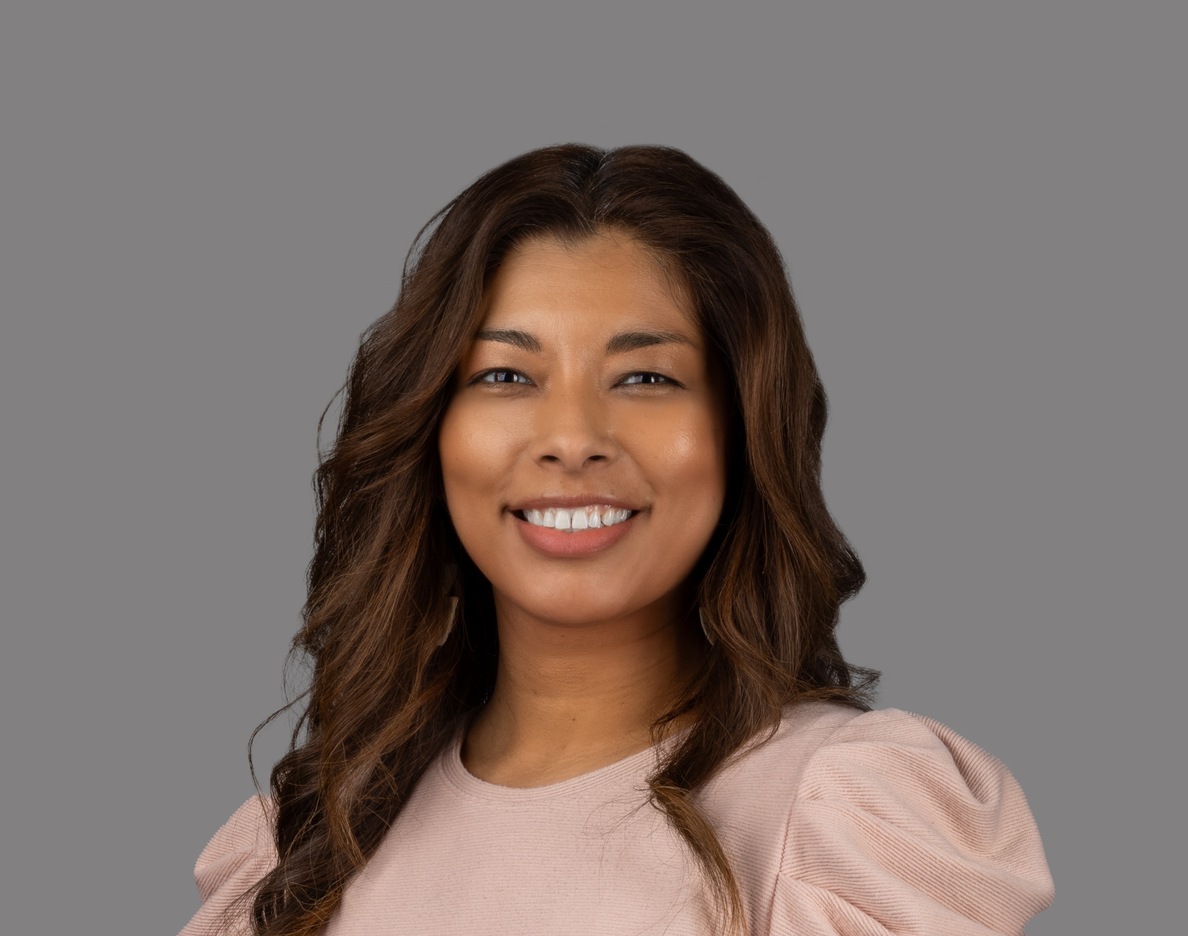 professional headshot of woman in pink shirt