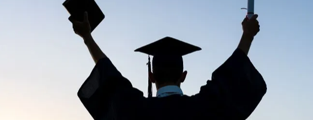 Graduate looking into sunset