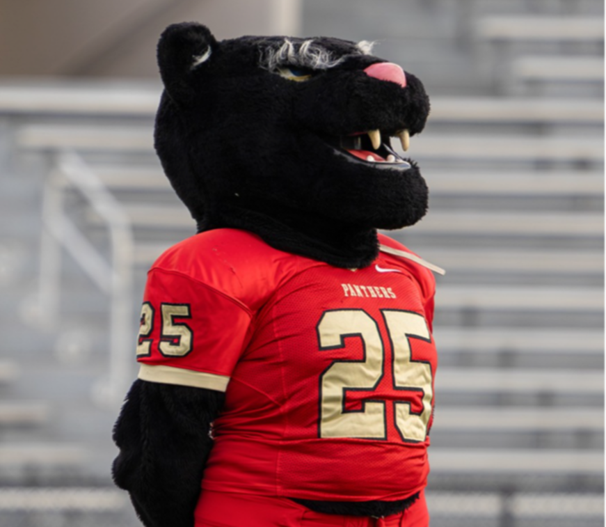 Caney Creek Panther mascot in red football uniform.