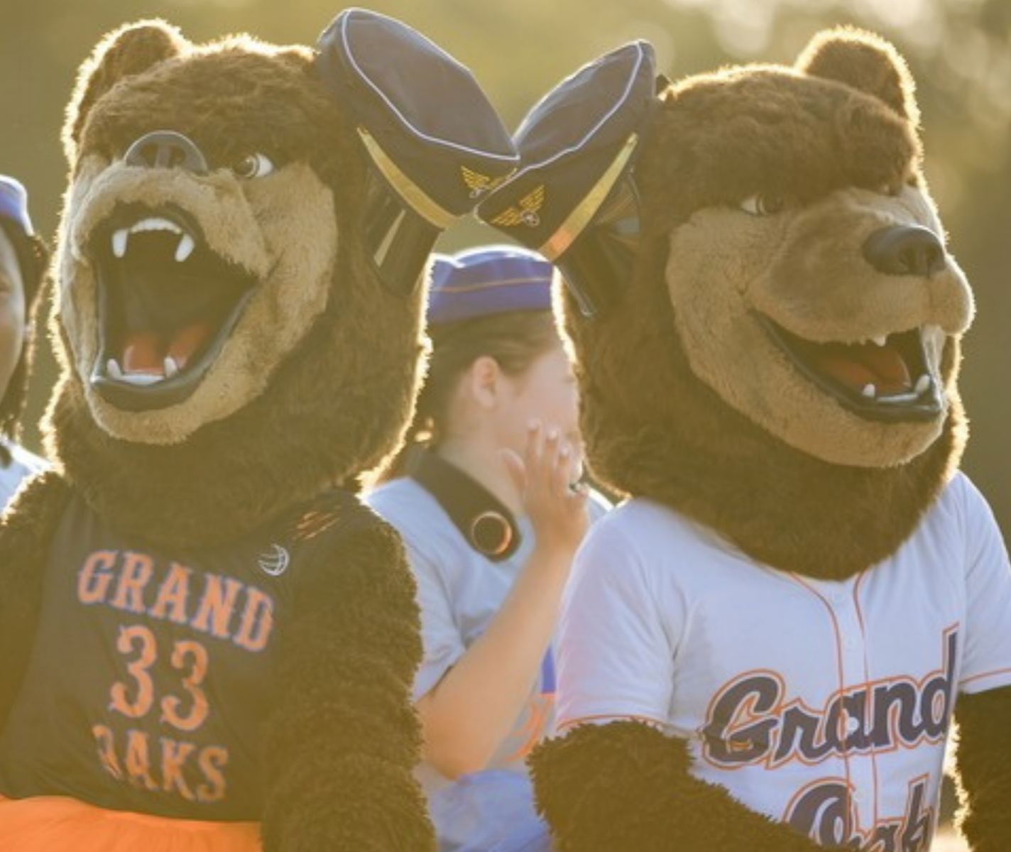Grand Oaks High School bear mascots riding in a car.