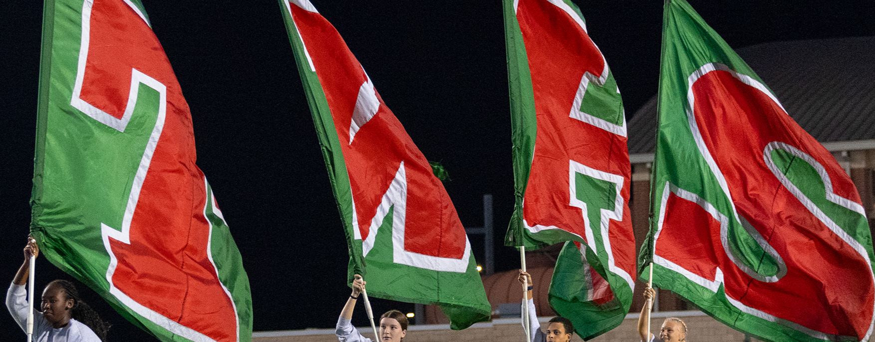 Green and red flags that spell out T-W-H-S