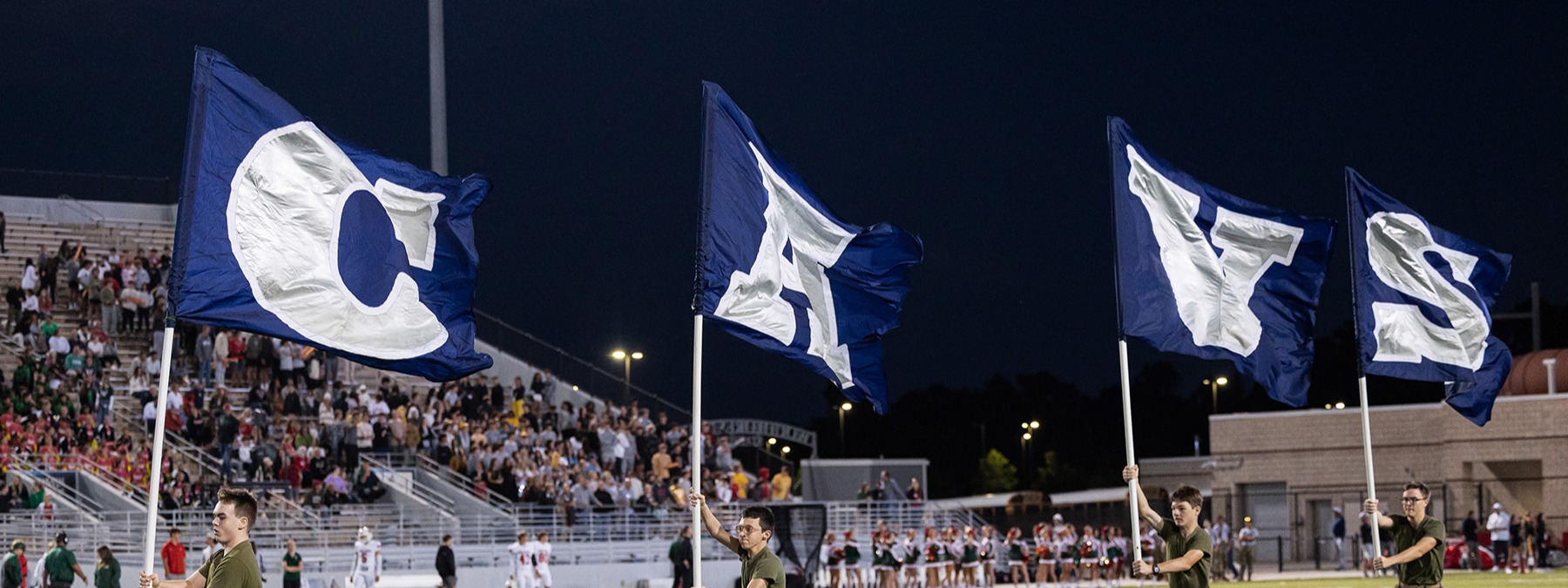 Navy blue flags that spell out C-A-V-S