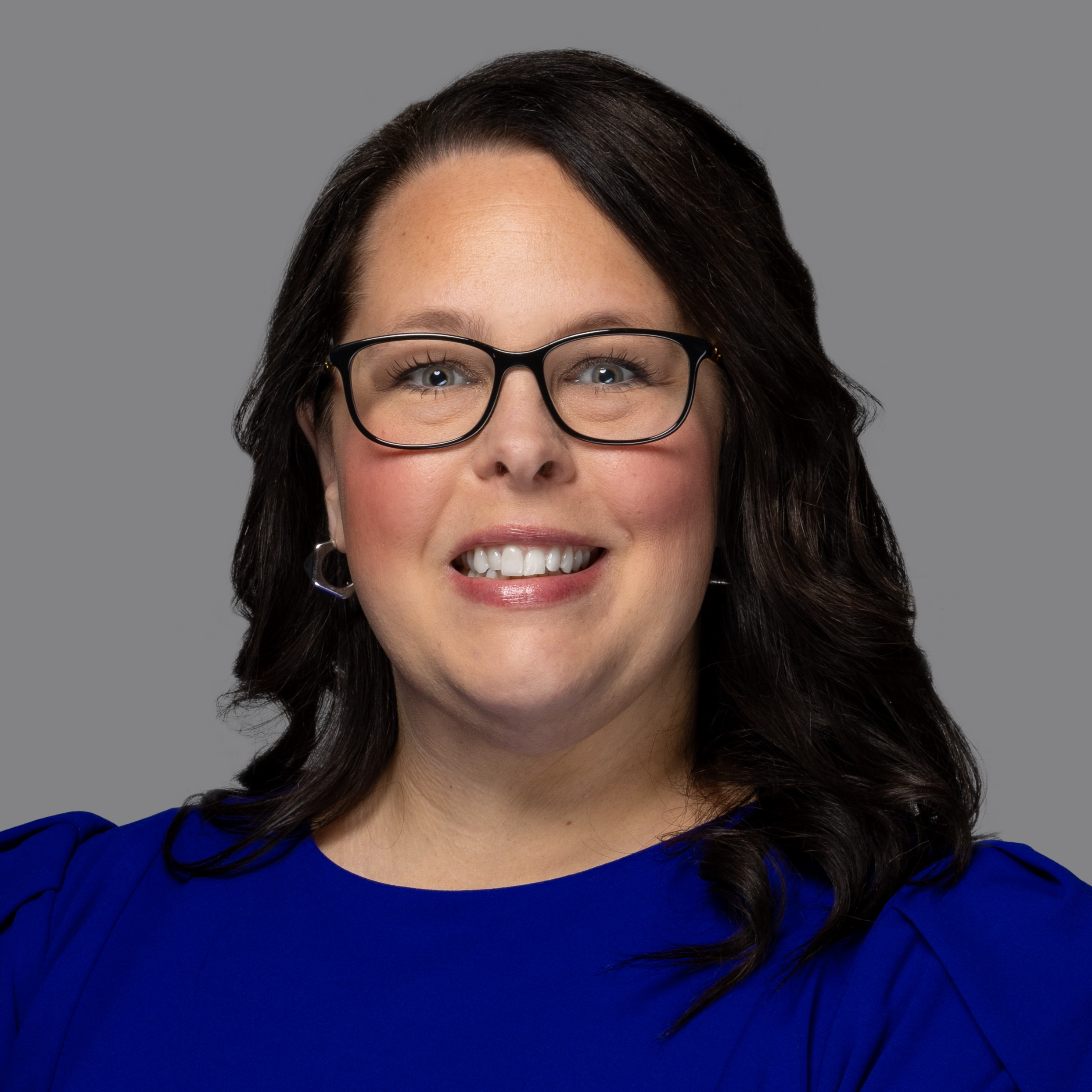 professional headshot of woman in blue dress