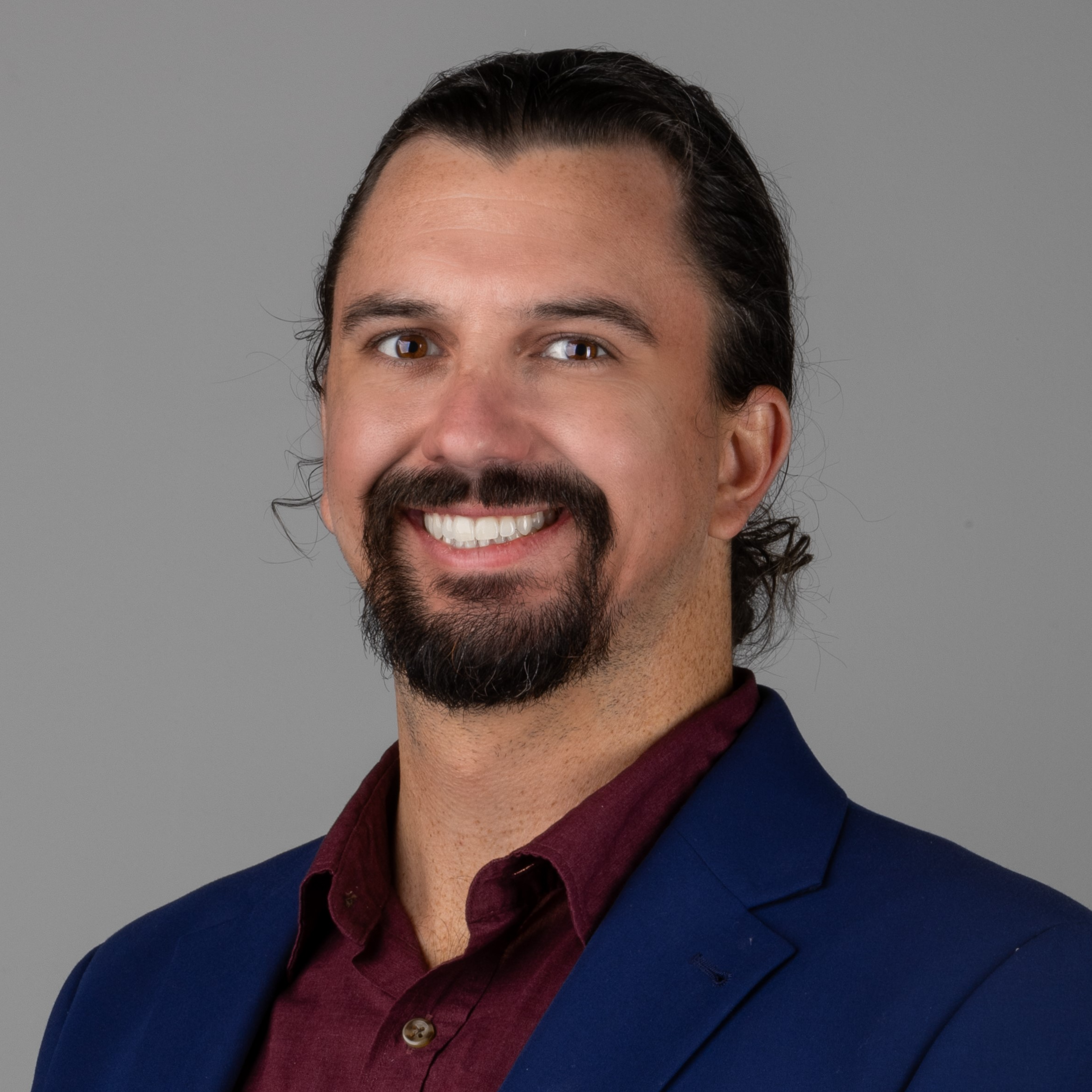 professional headshot of man in blue suit