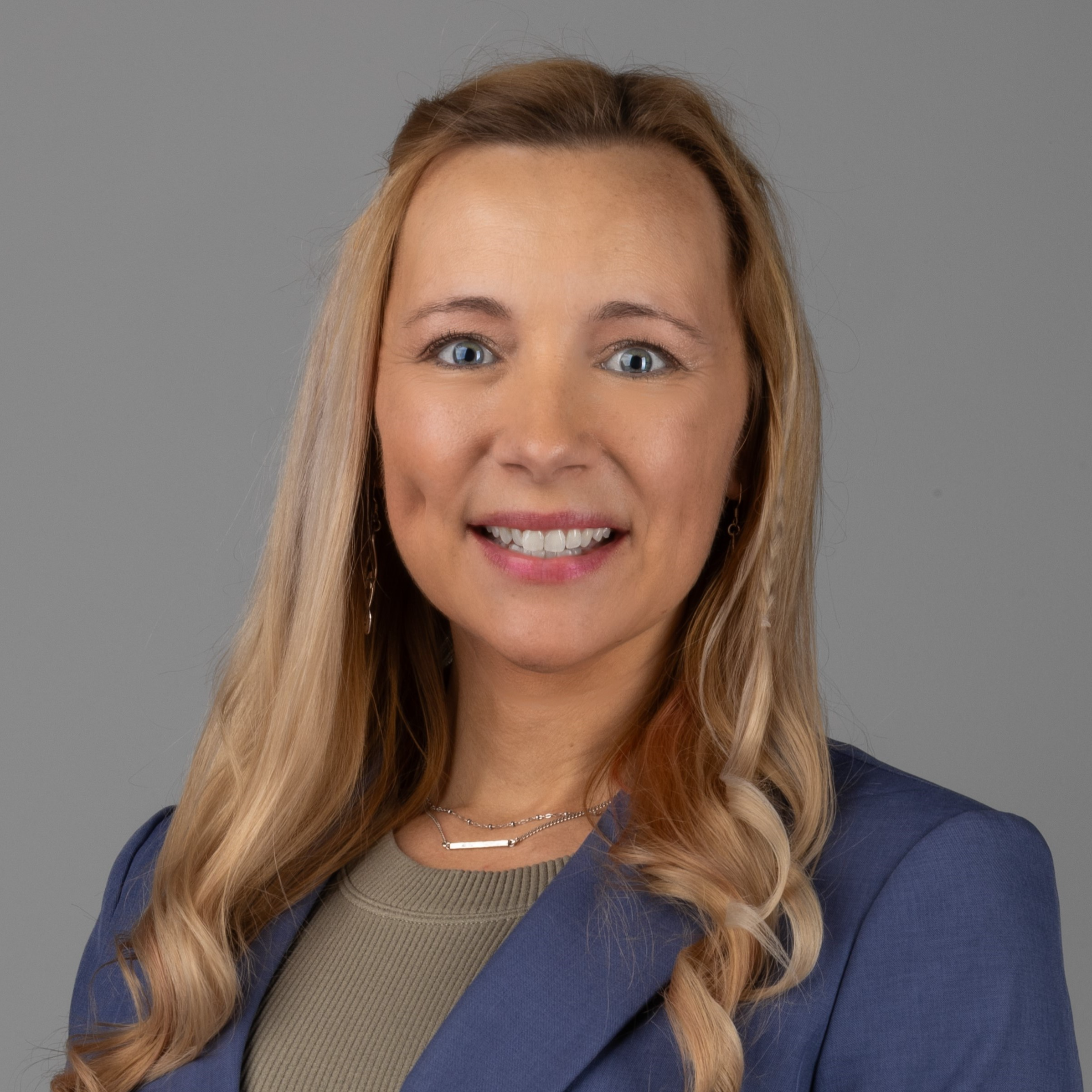professional headshot of woman in blue suit