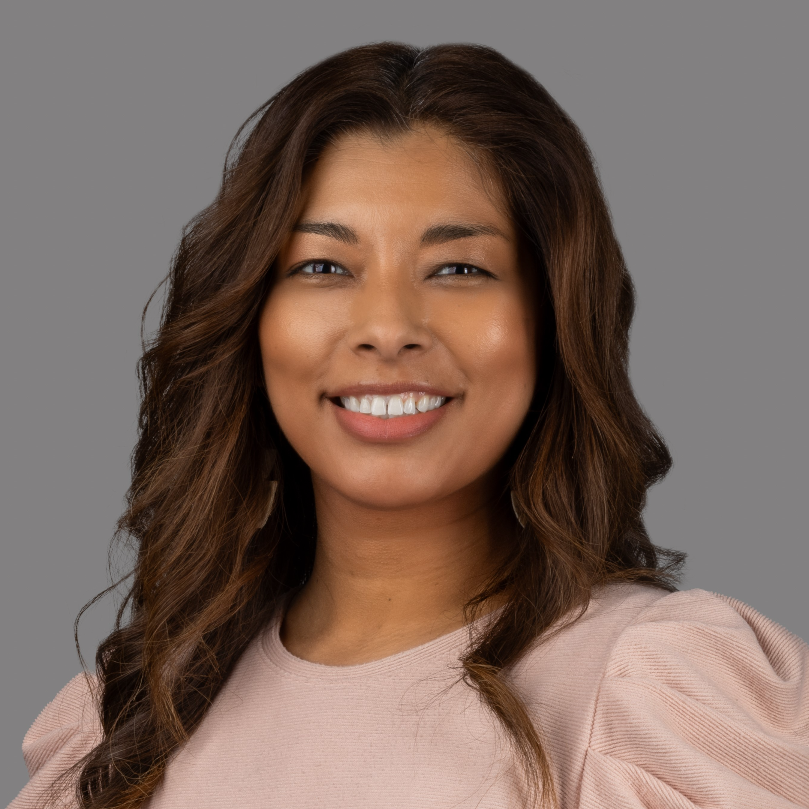 professional headshot of woman in pink shirt