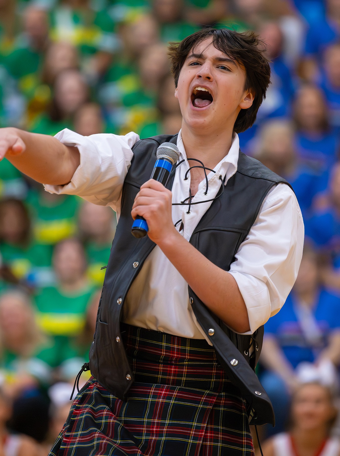 The Woodlands High School Highlander mascot dressed in tartan kilt, white shirt and vest