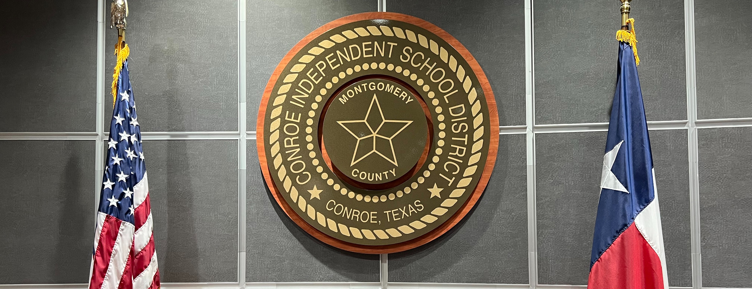 Conroe Independent School District seal with American and Texas flags