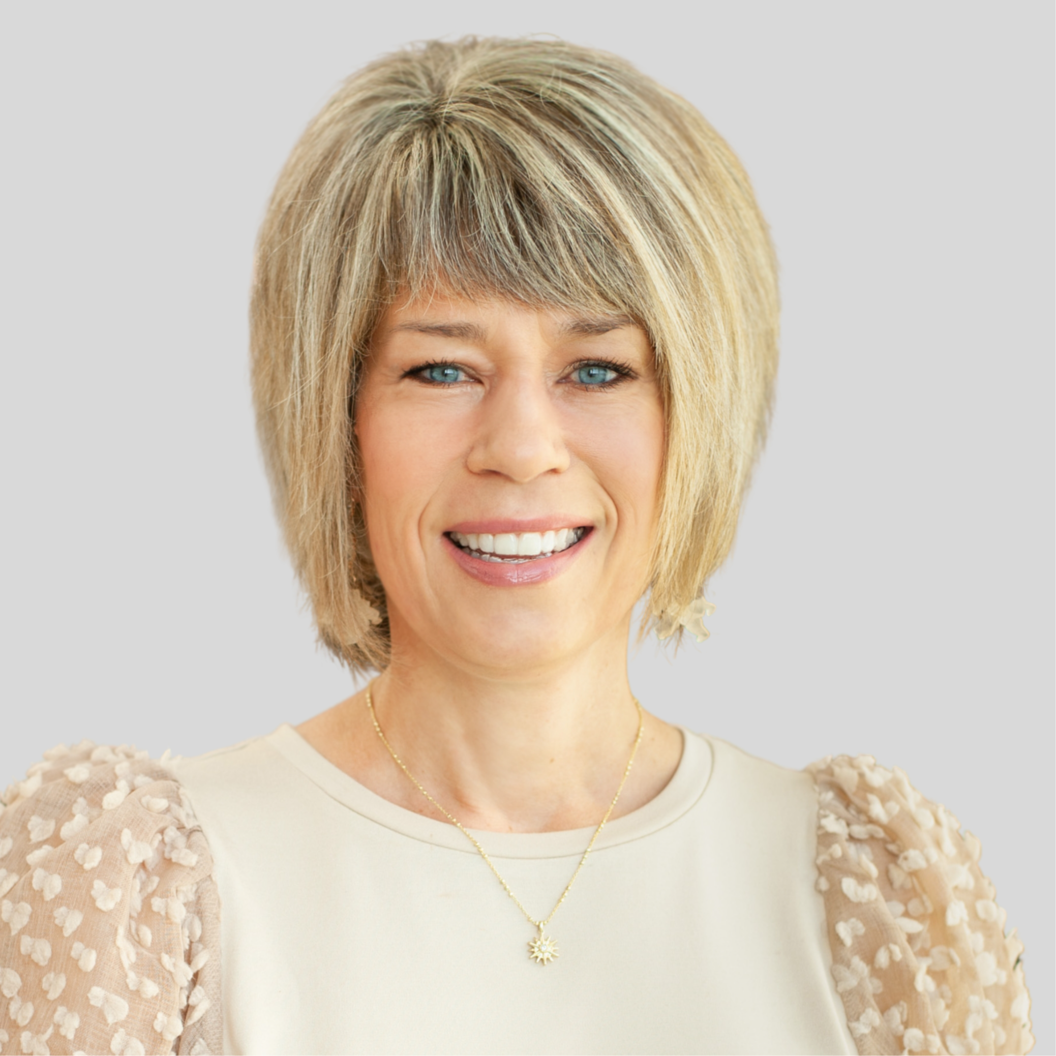 Headshot of Amy Wilson, Early Childhood Specialist. She is wearing a cream colored shirt . She has chin length blonde hair and blue eyes