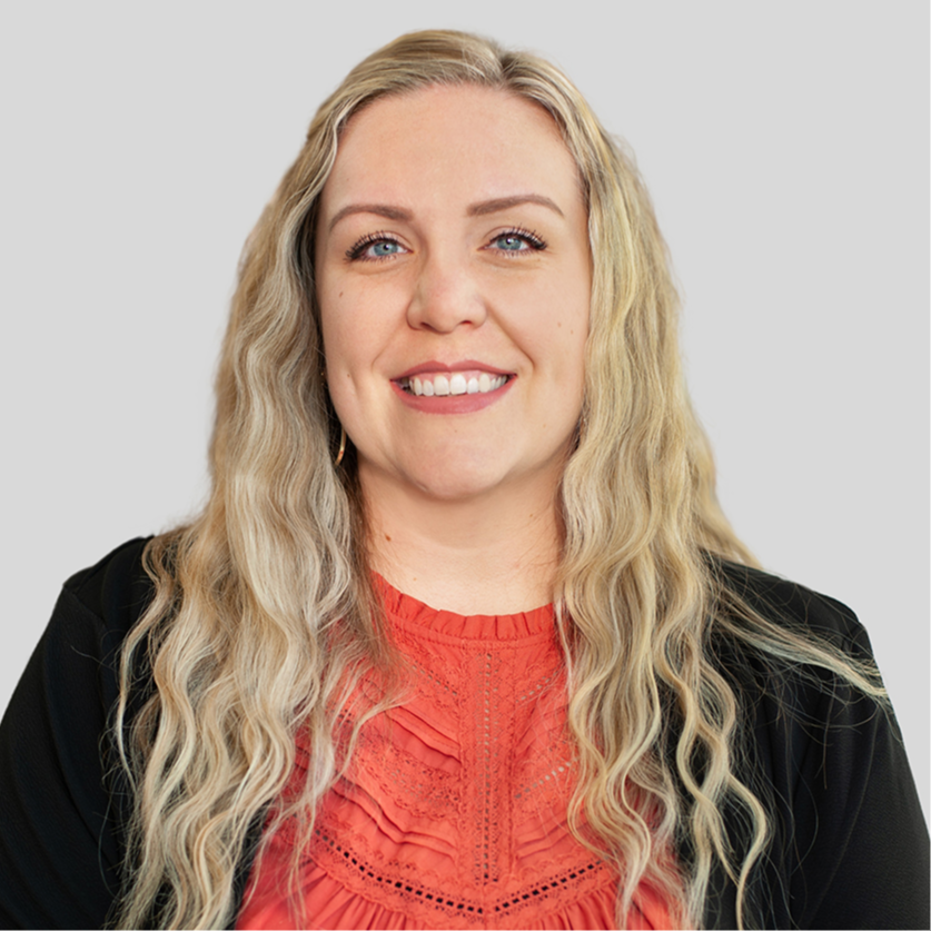 Headshot of Jillian Lindeman, Early Childhood District Instructional Coach. She is wearing a black blazer and red blouse . She ha long blonde hair and blue eyes.