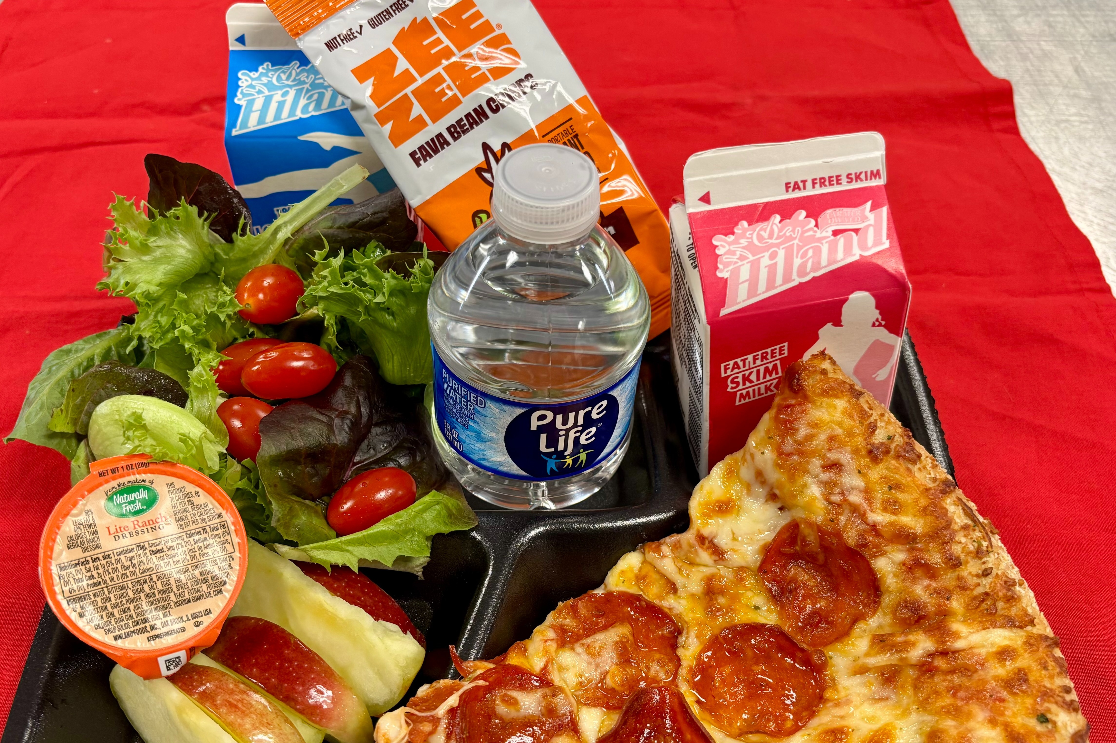 Pepperoni pizza, buffalo ranch fava beans, side salad, apple slices, milk, and water