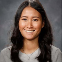 A young woman with long hair smiling at the camera.