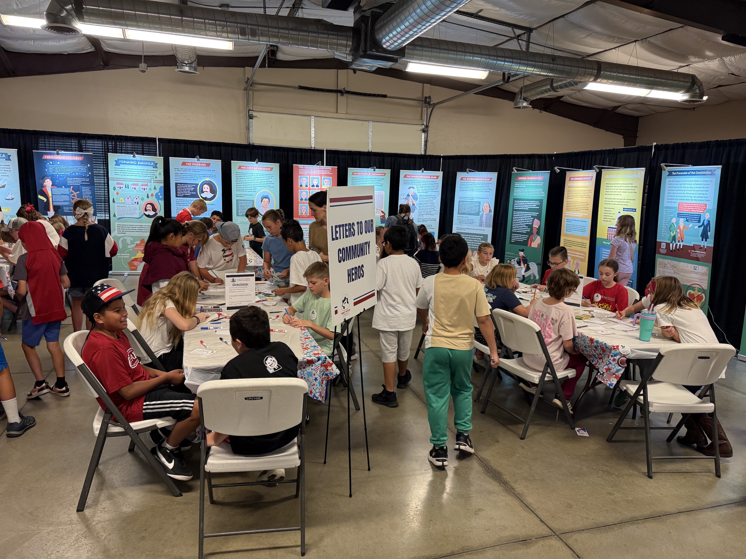 Students writing letters to community heros.