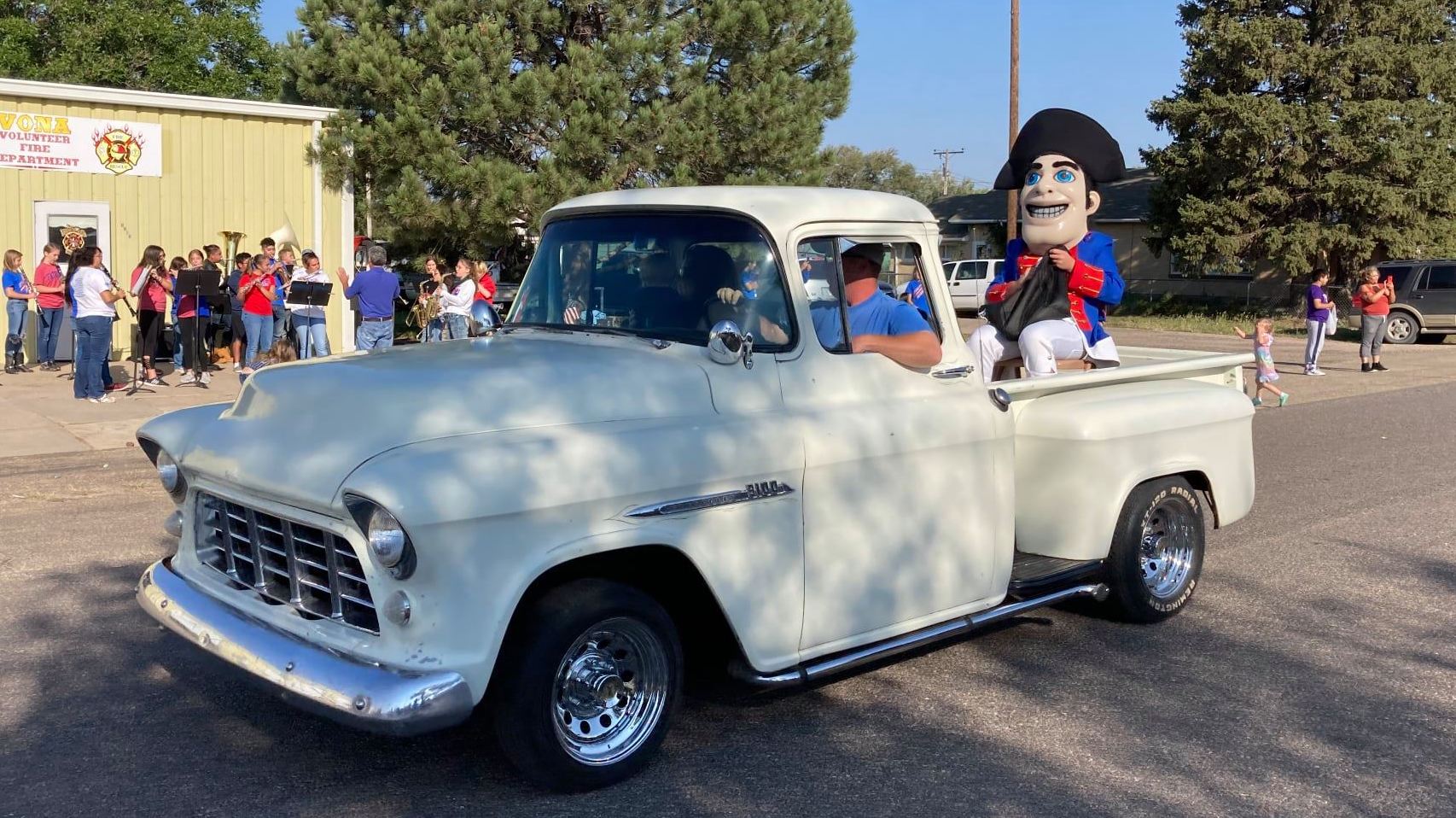 patriot mascot riding in the back of a truck