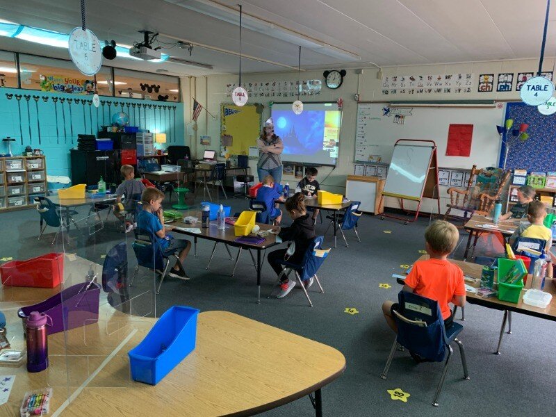 A group of children sitting at desks in a classroom