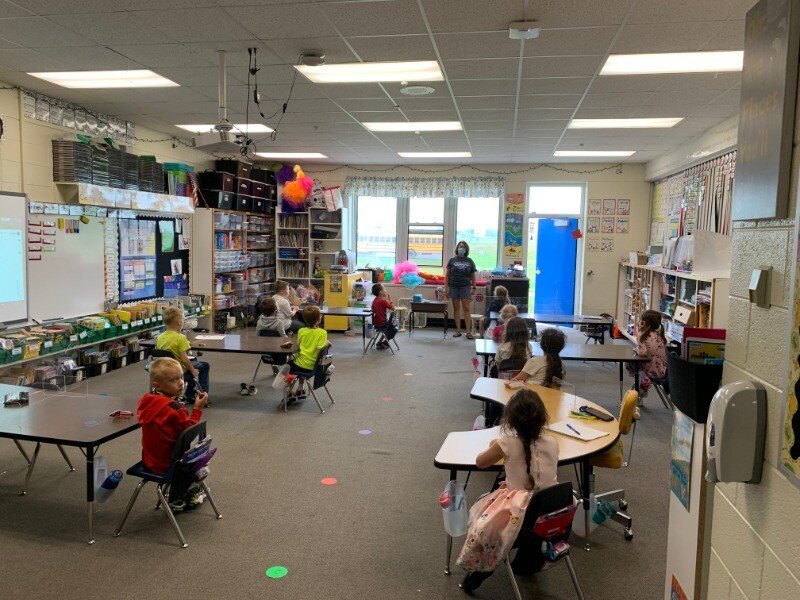 A group of children sitting at desks in a classroom