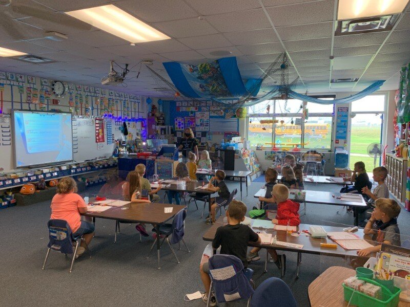 A group of children sitting at desks in a classroom