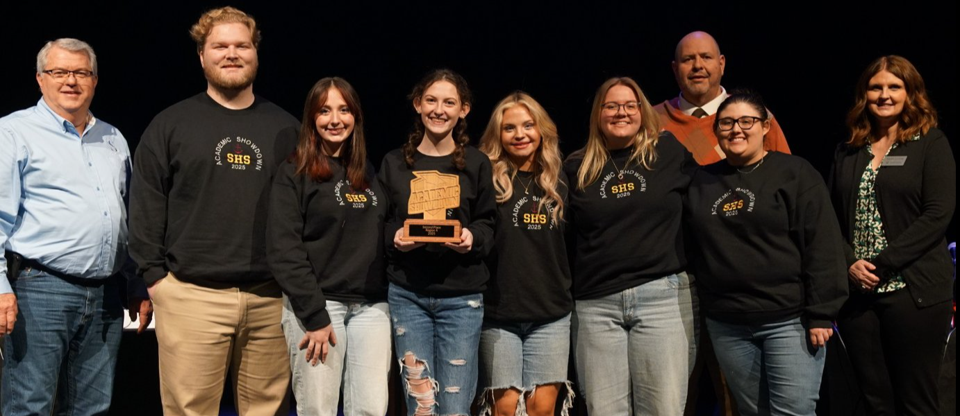people smiling with award