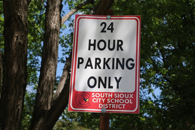 A red and white sign that says 24 hour parking only