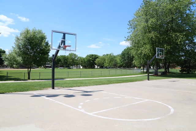 A basketball court with a basketball hoop in the middle of it