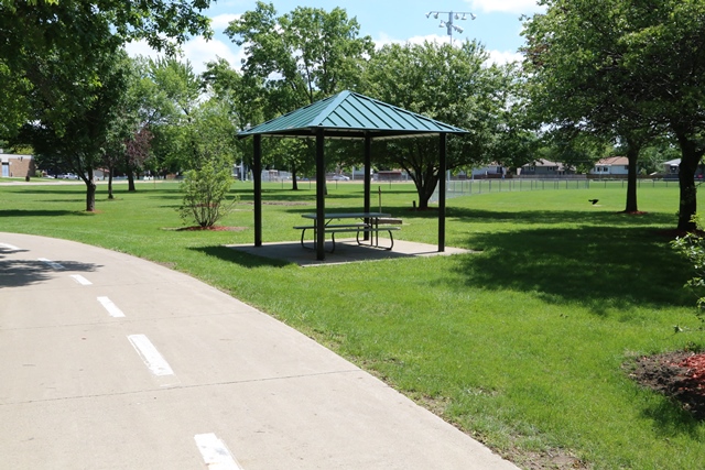 A park with a picnic table and a gazebo