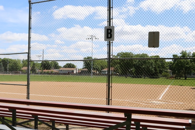 A view of a baseball field through a fence