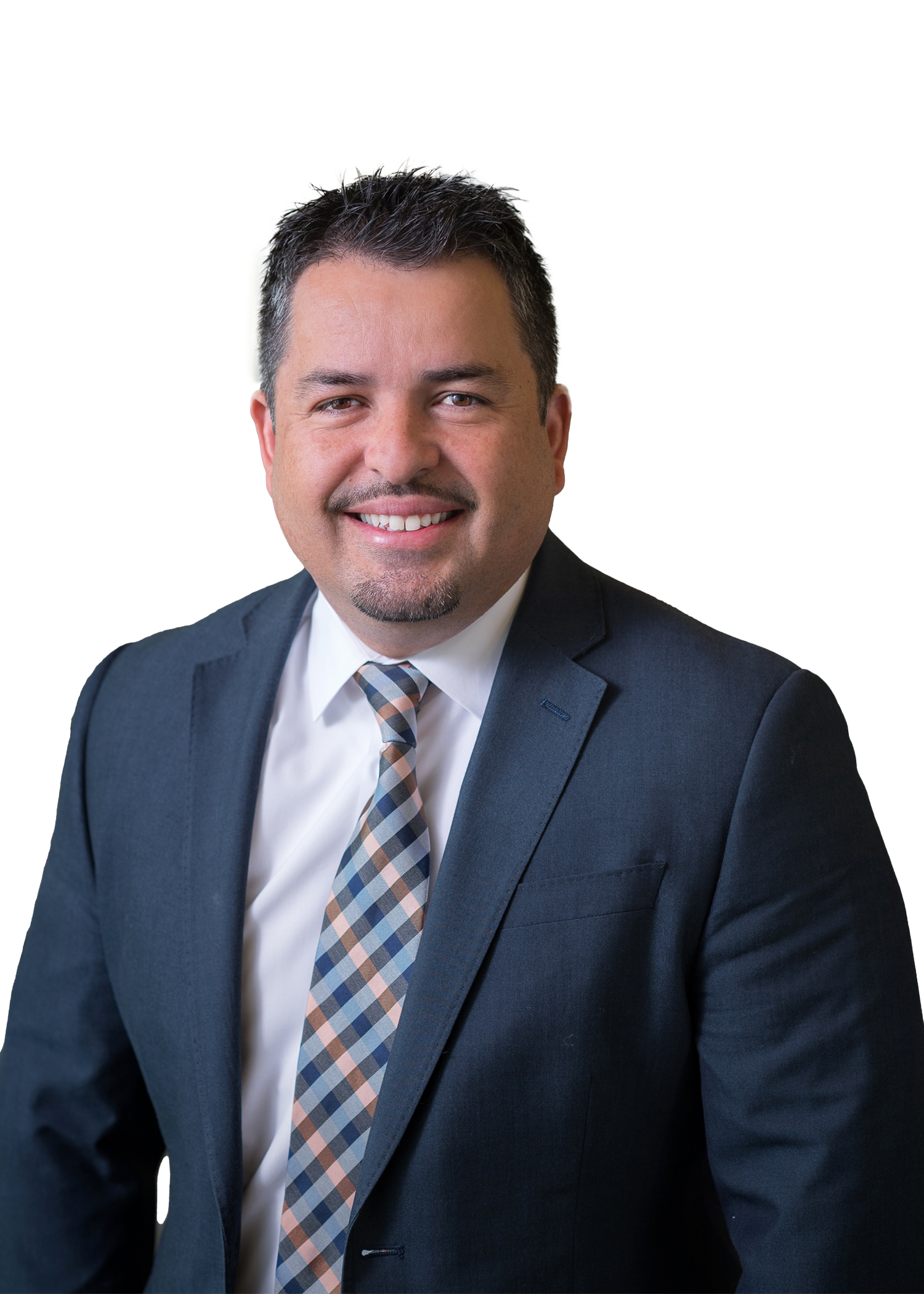 A man in a suit and tie smiles confidently, exuding professionalism and approachability in a polished setting.