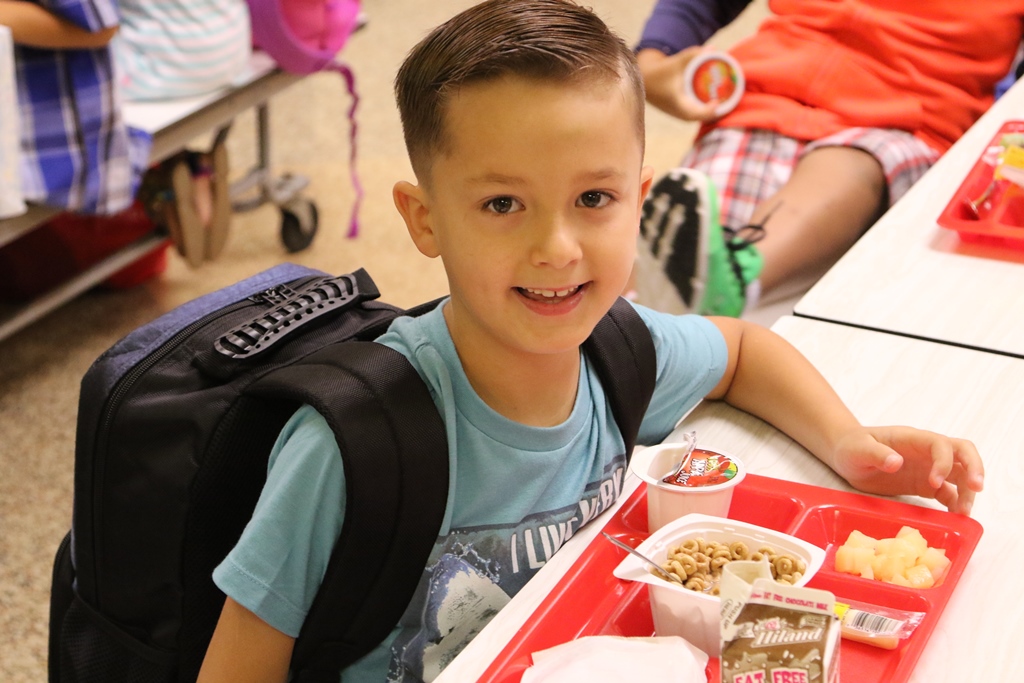 A boy student with his meal