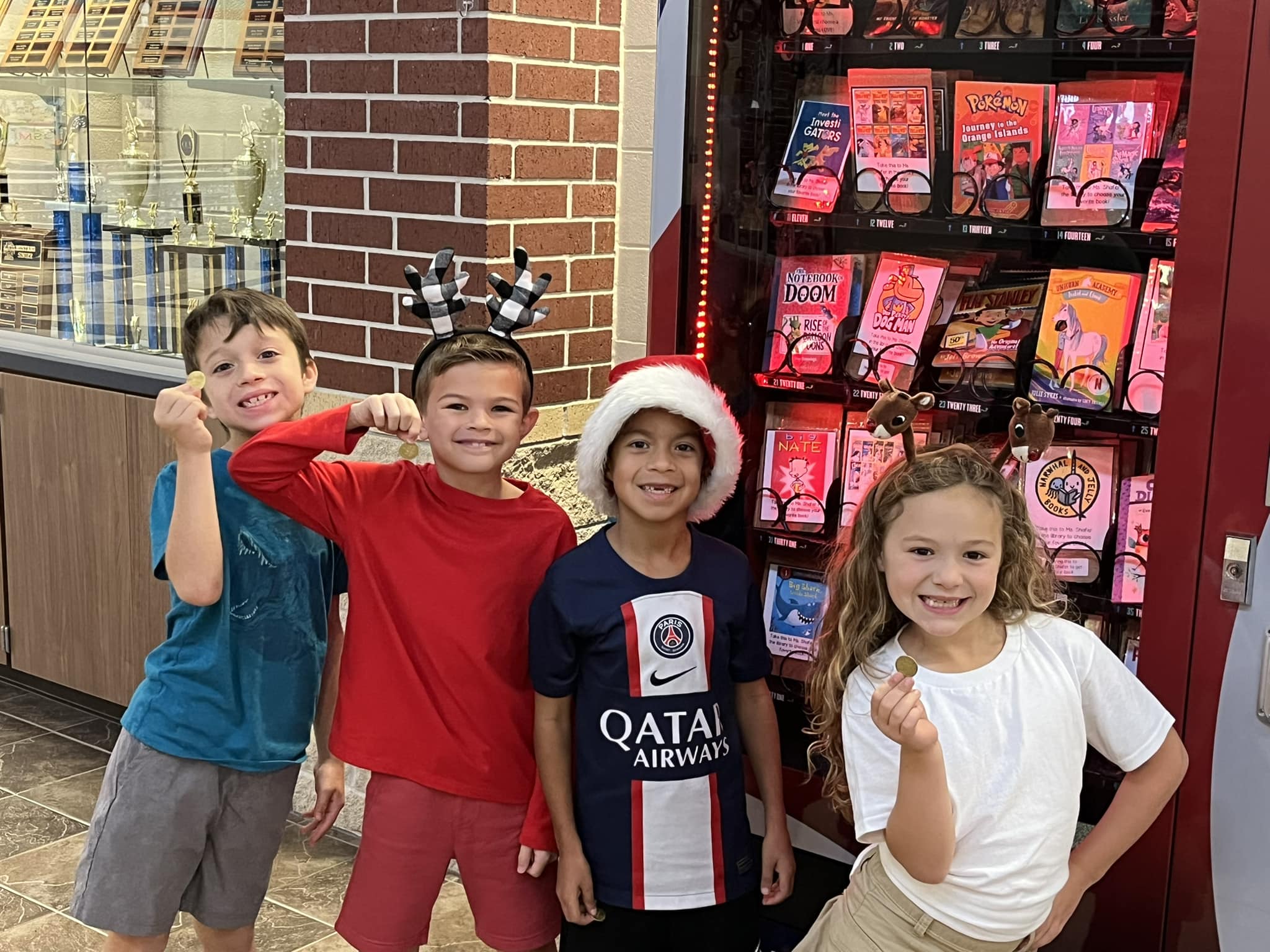 Students choosing a book from the book vending machine.