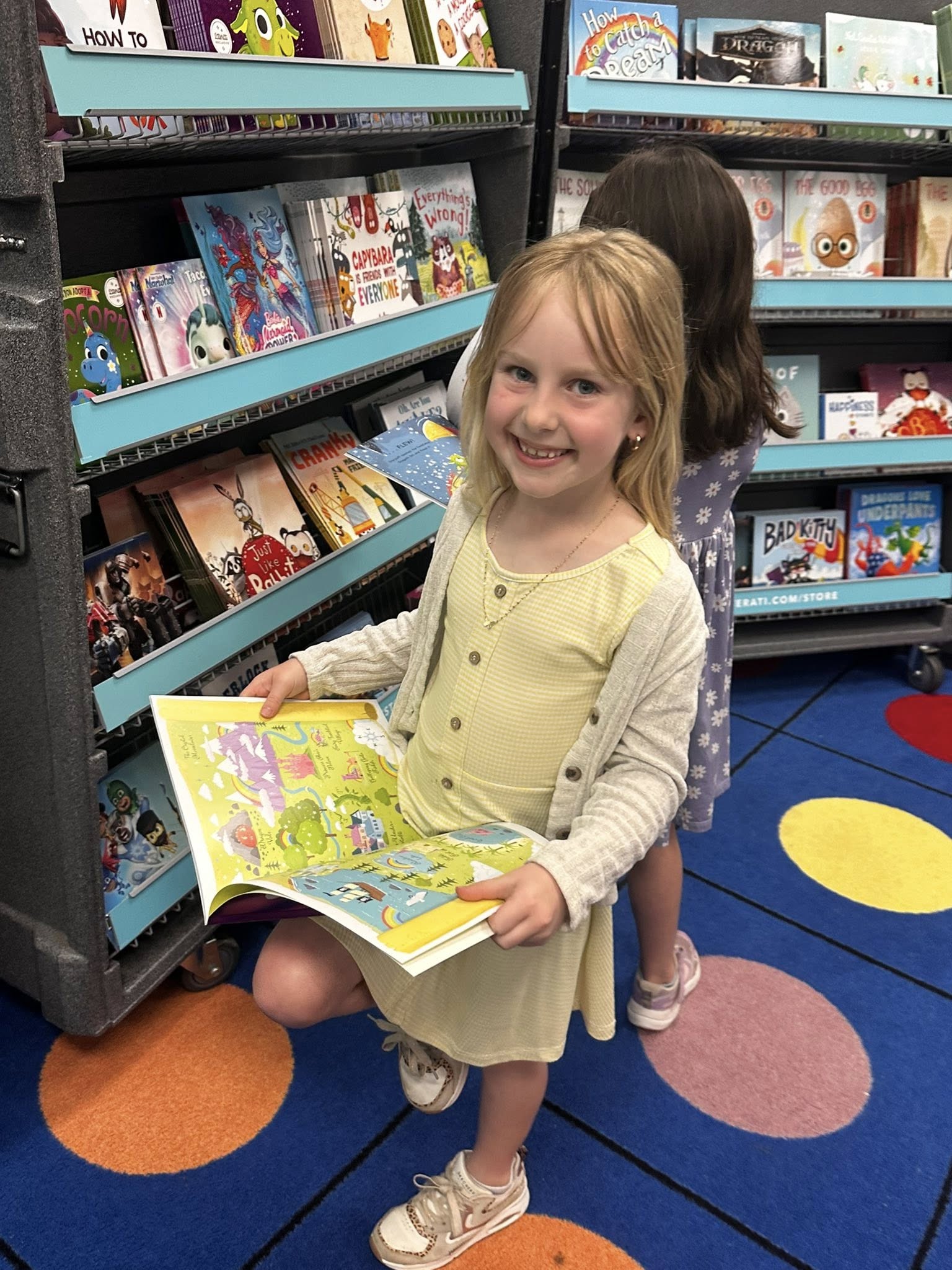 A student enjoys shopping at the book fair in the library