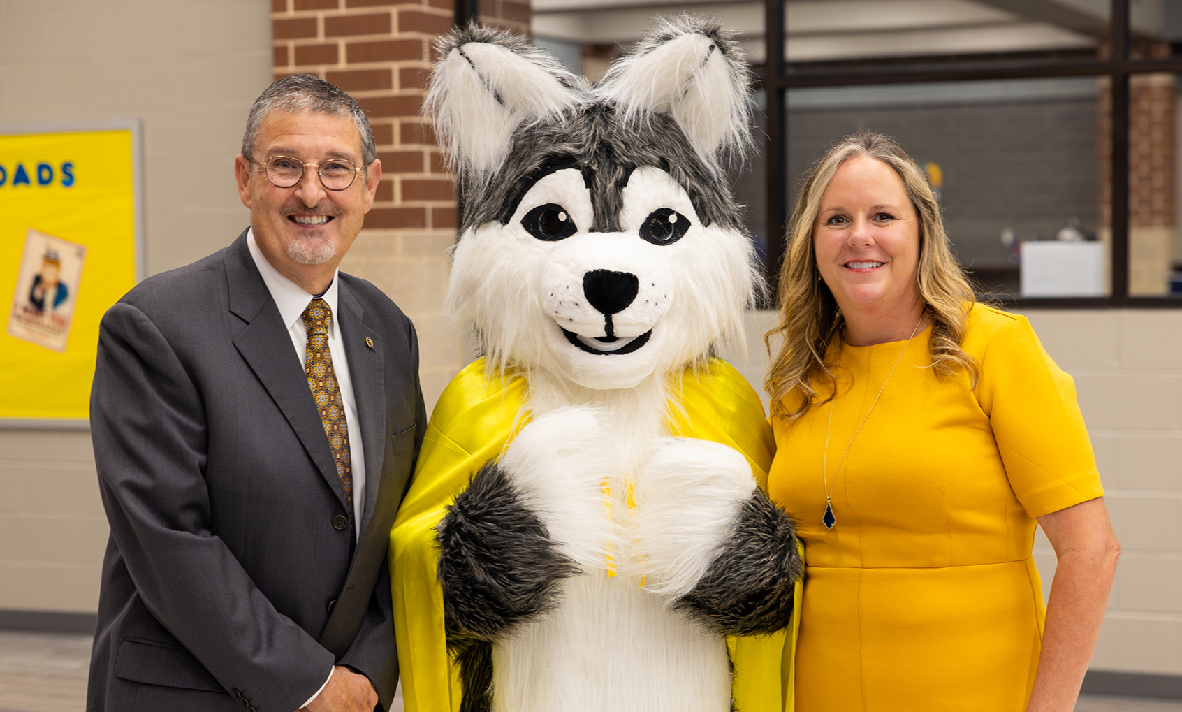 Dr. Chris Hines and Principal Erin Mathe with the Hines Husky mascot.