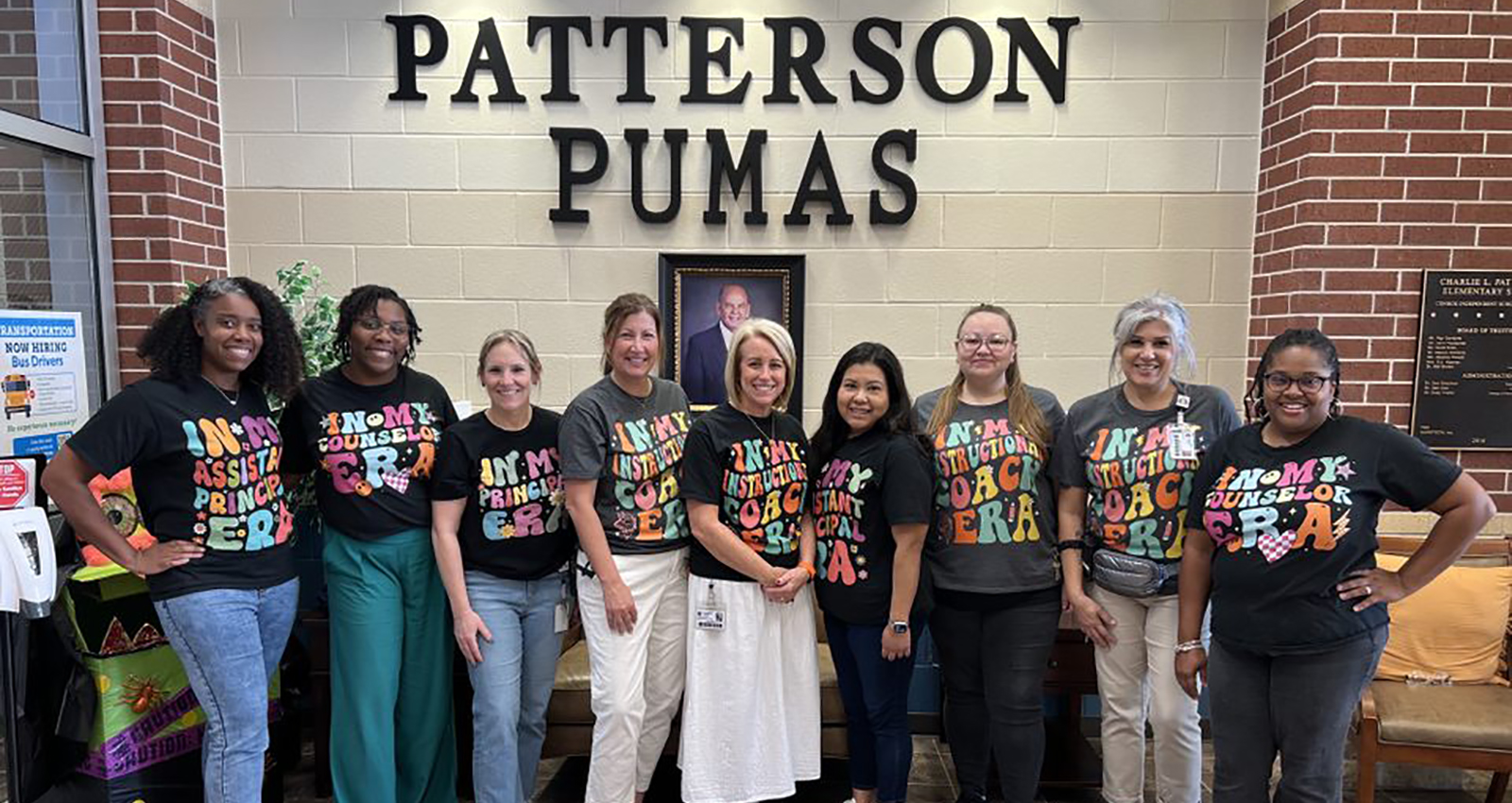 Patterson administrators wearing matching black "In My Era" T-shirts.
