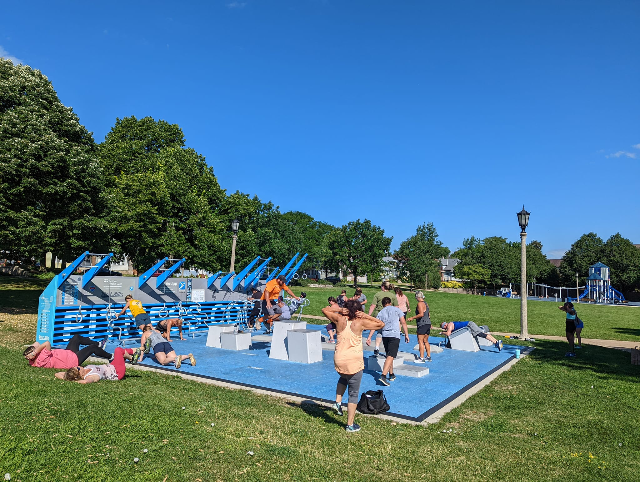 A lively playground scene with children playing joyfully on swings and slides in a sunny park setting.