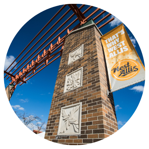 A brick building featuring a prominent sign that reads "West Falls," showcasing its welcoming entrance.