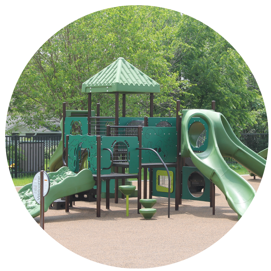 A vibrant playground featuring green slides and a charming green roof, inviting children to play and explore.