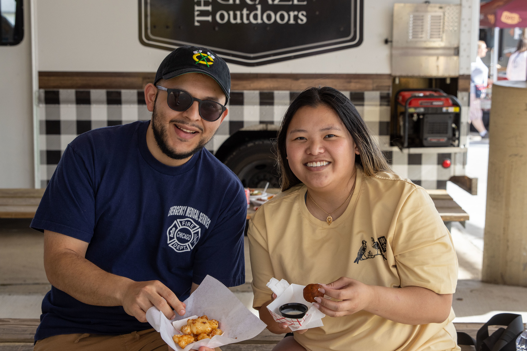 A couple poses with food purchased at Food Truck Friday