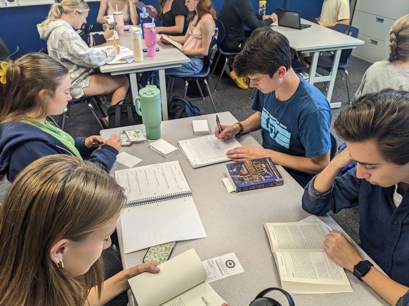 Students reading around a desk