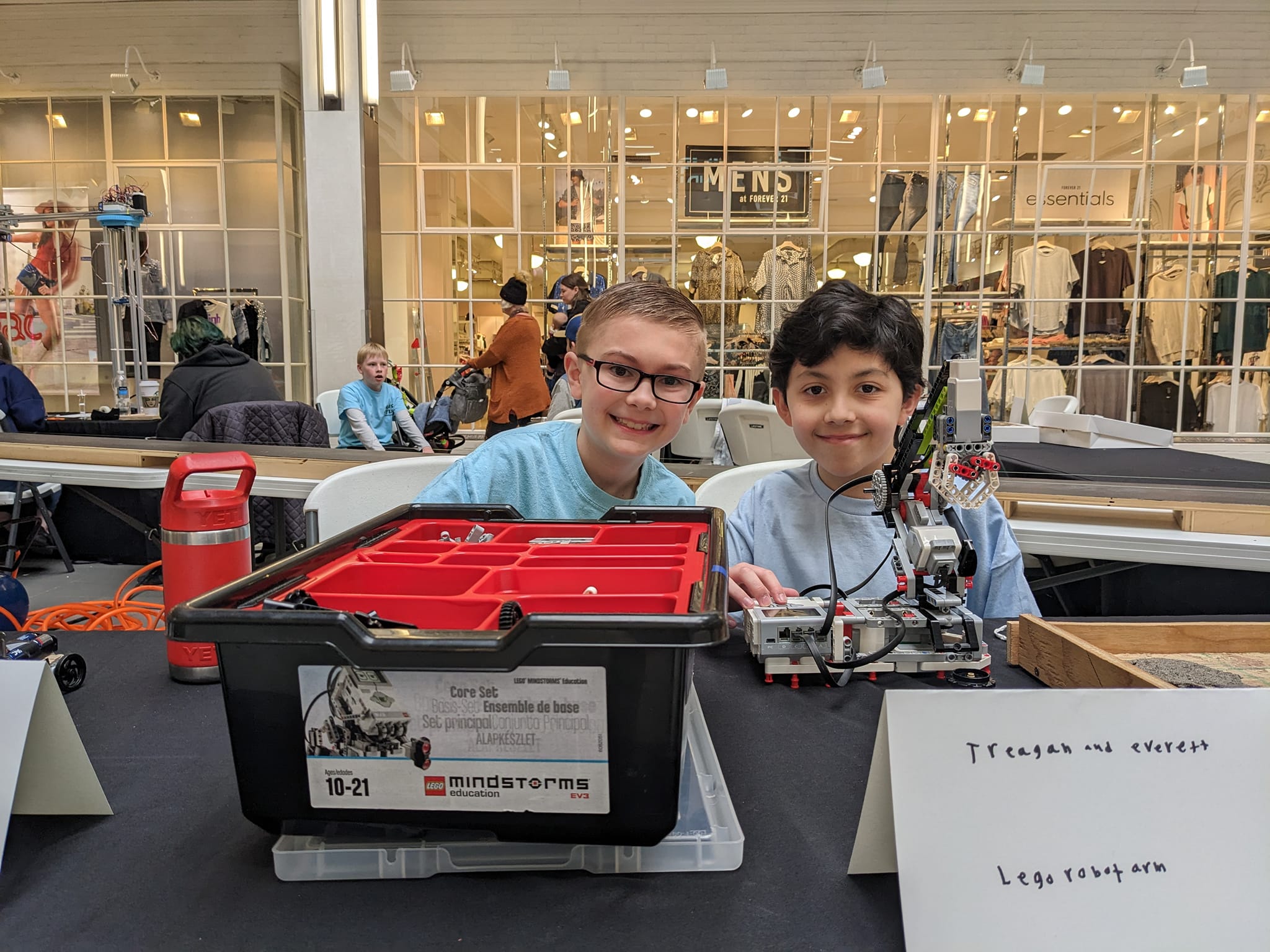 Two boys posing with STEM learning tools