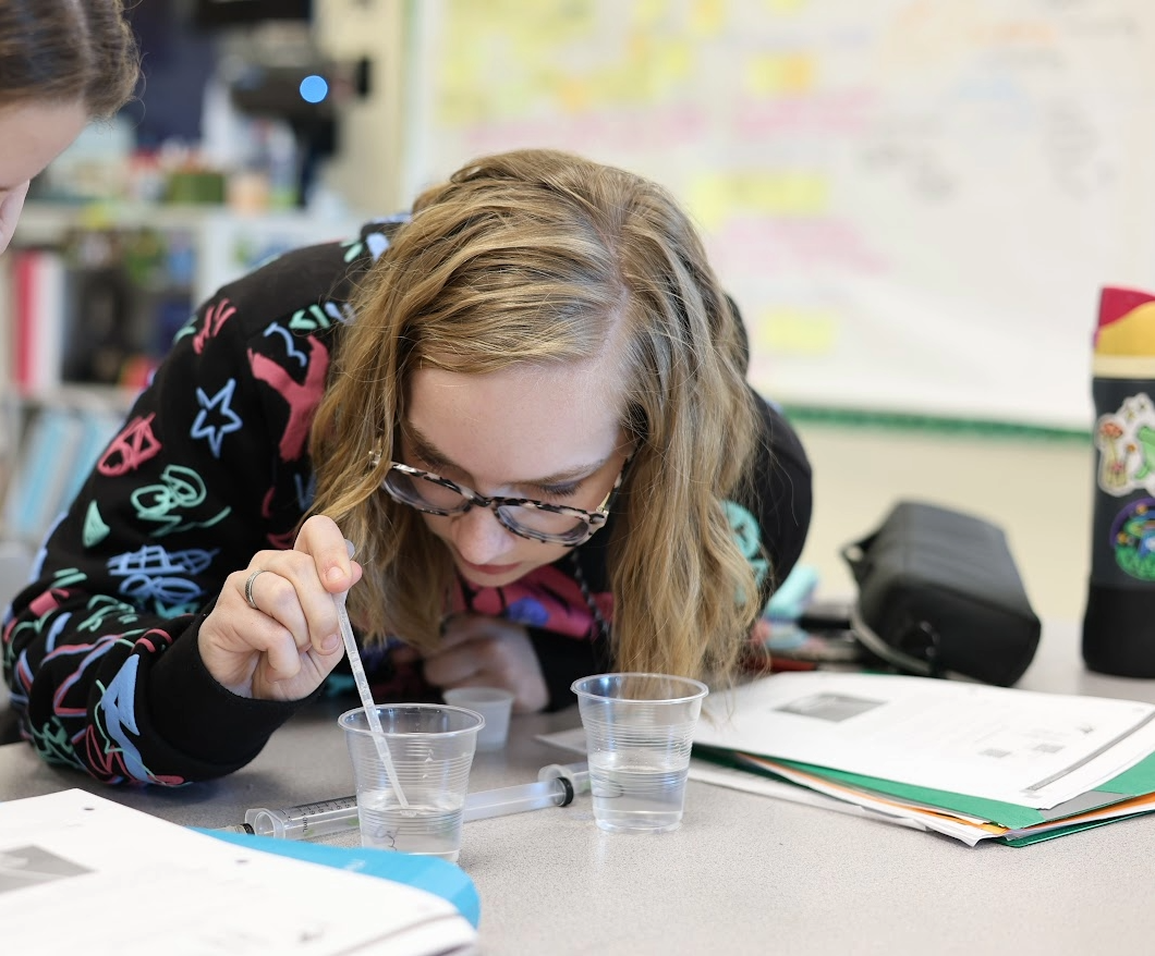 Student uses a dropper in a science lab.