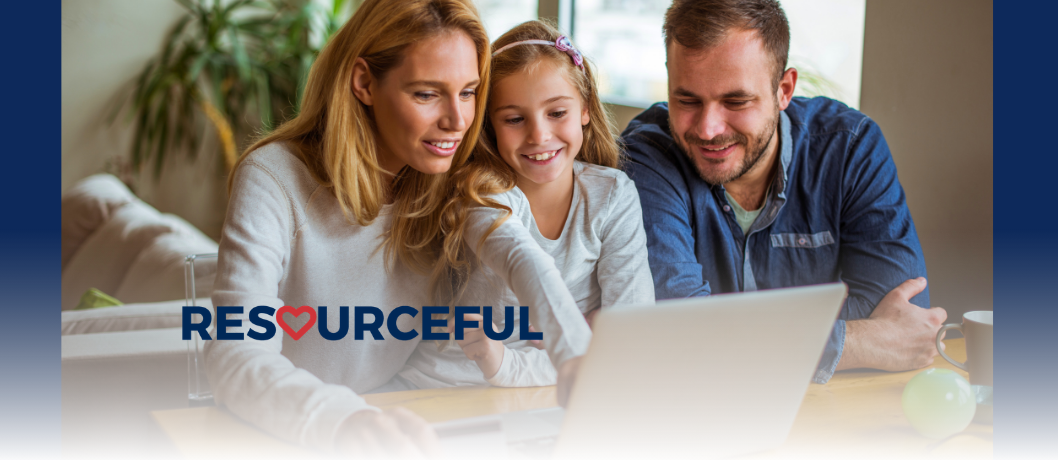 Stock photo of parents with their child looking at a laptop.