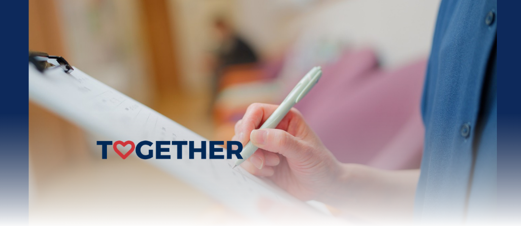 Stock image of person's hand writing on a clipboard.