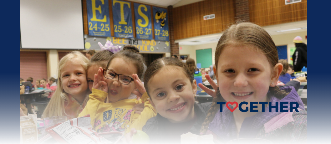 Kindergarten students together at the lunch table.