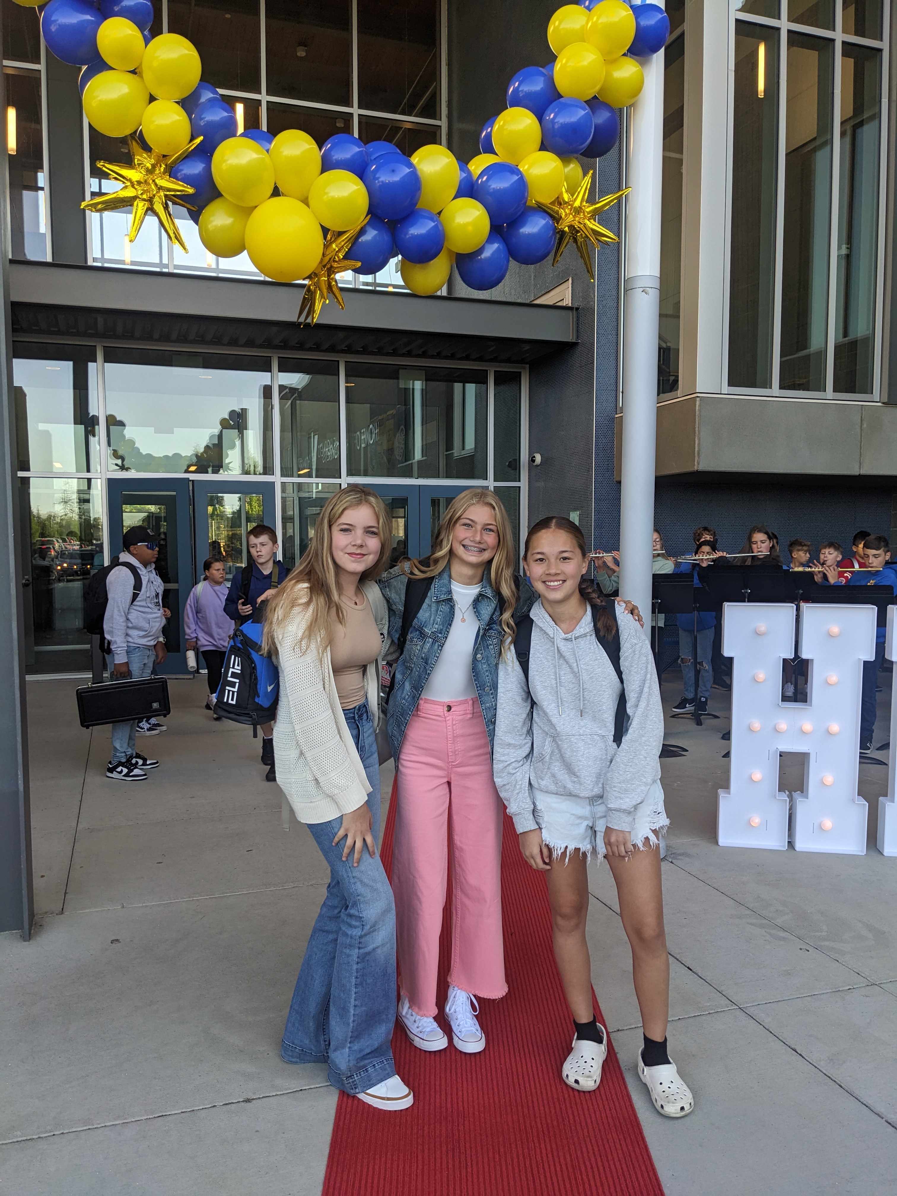 Middle school students in front of school