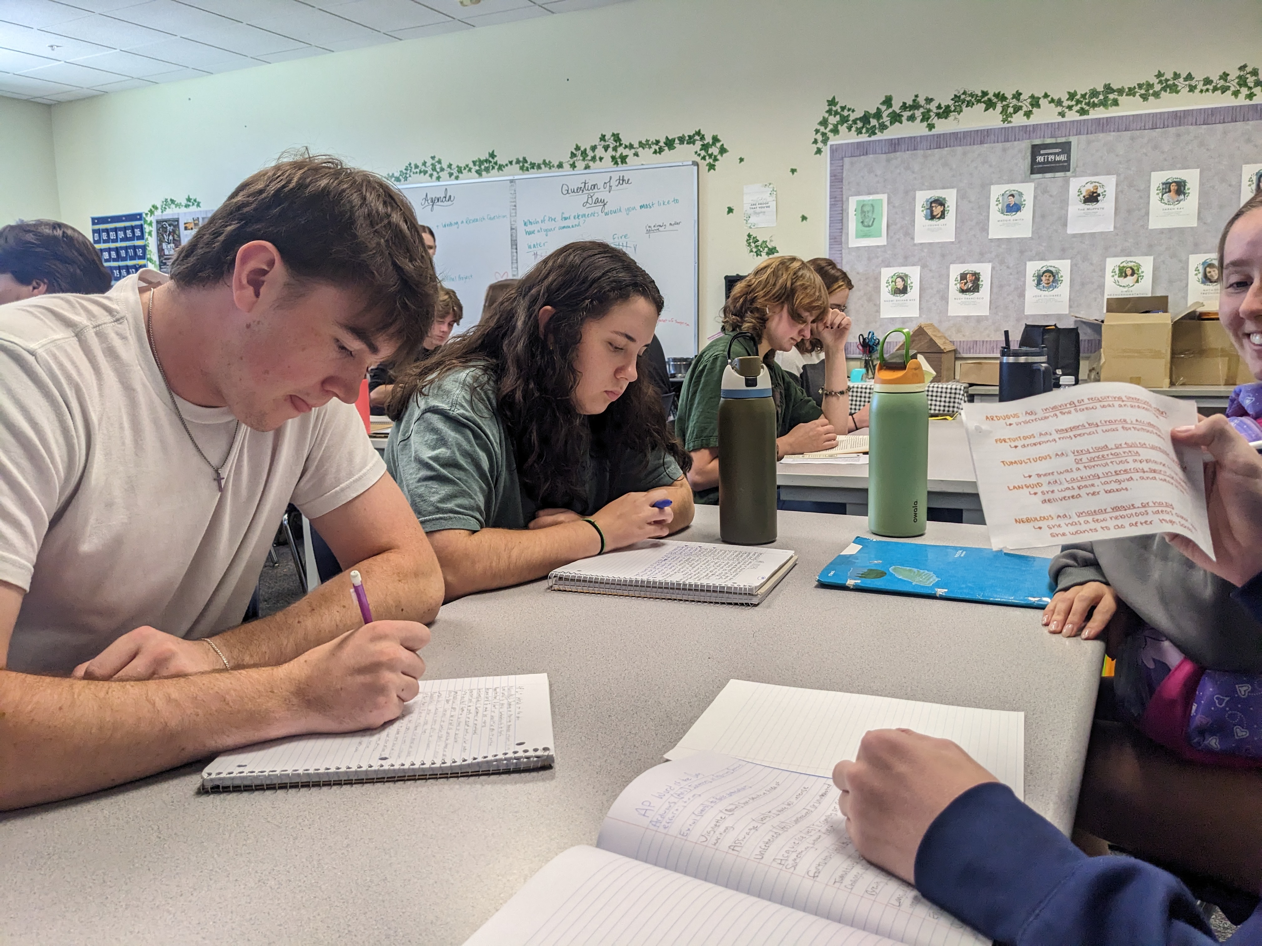 Students write using desks