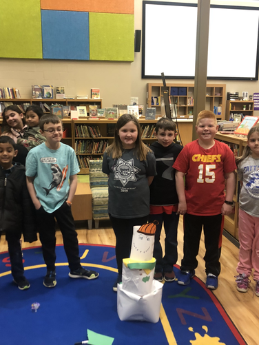 A group of children standing in a library