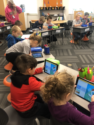 A group of children sitting at desks in a classroom