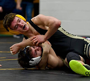 Wrestler attempting takedown on opponent during match.